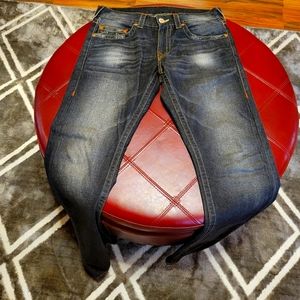 Men's size 31 faded True Religion blue jeans.